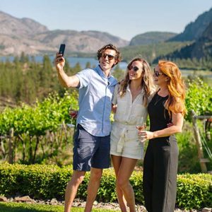 Three Noble Ridge guests taking a selfie in the vineyard