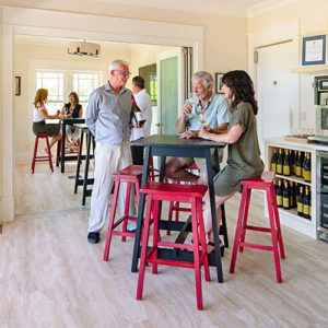 Man talking to a couple inside Noble Ridge tasting room